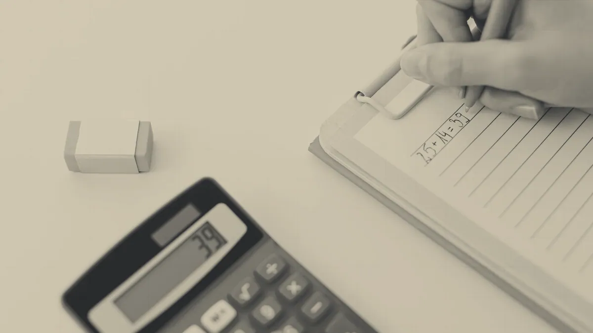 A calculator and a notebook: the sum, not the shop.