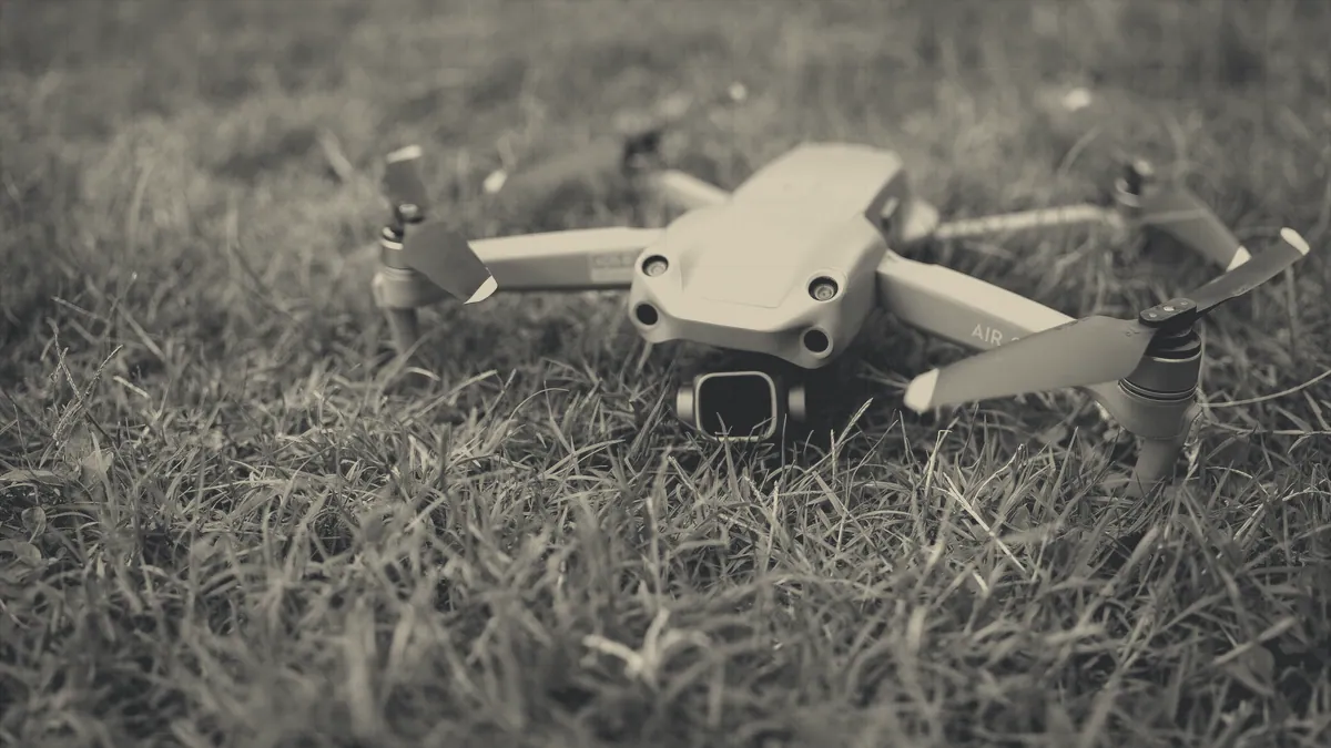 A four-rotor machine sitting on grass.