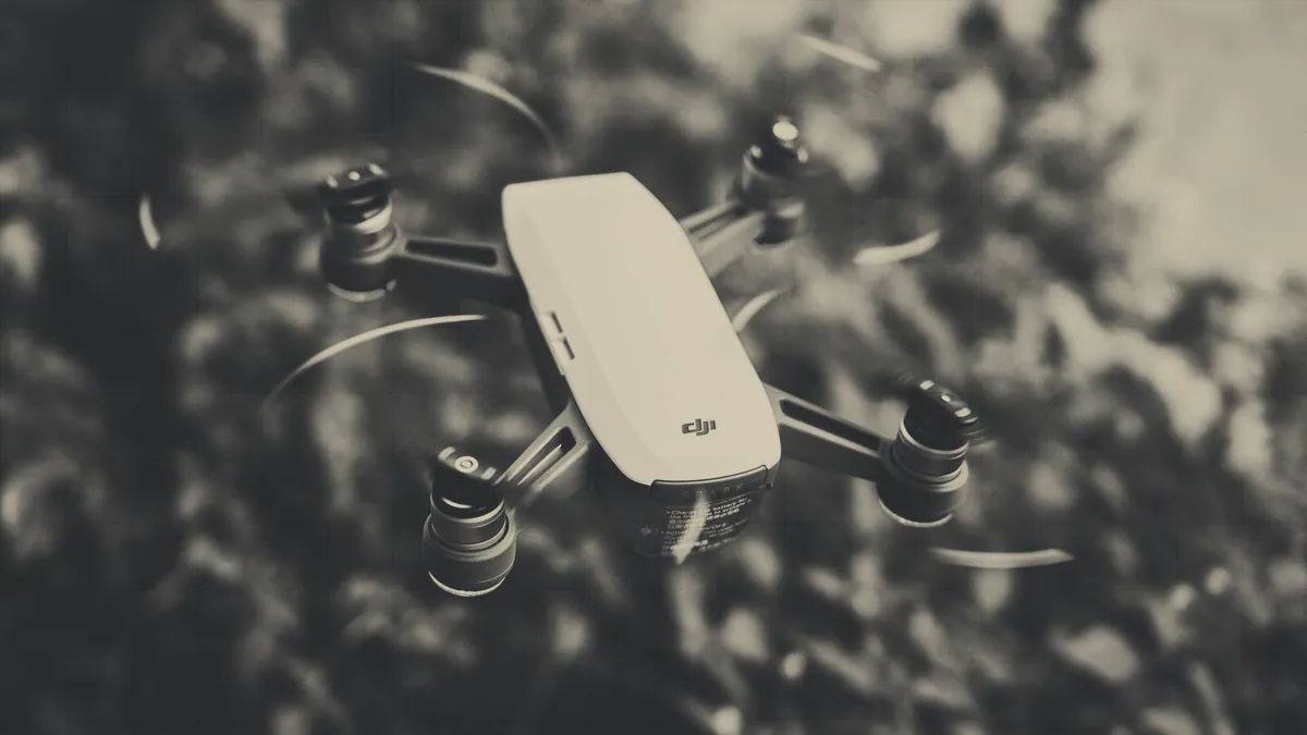 A toy quadcopter on the floor indoors.